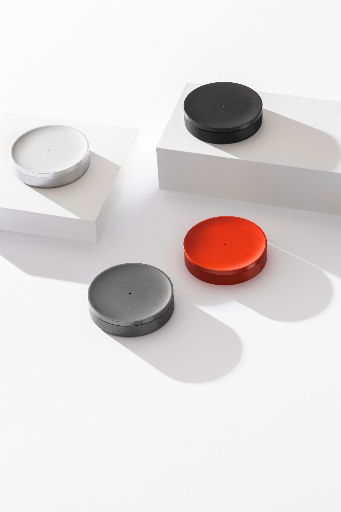 Tiller devices in four colours on white surface